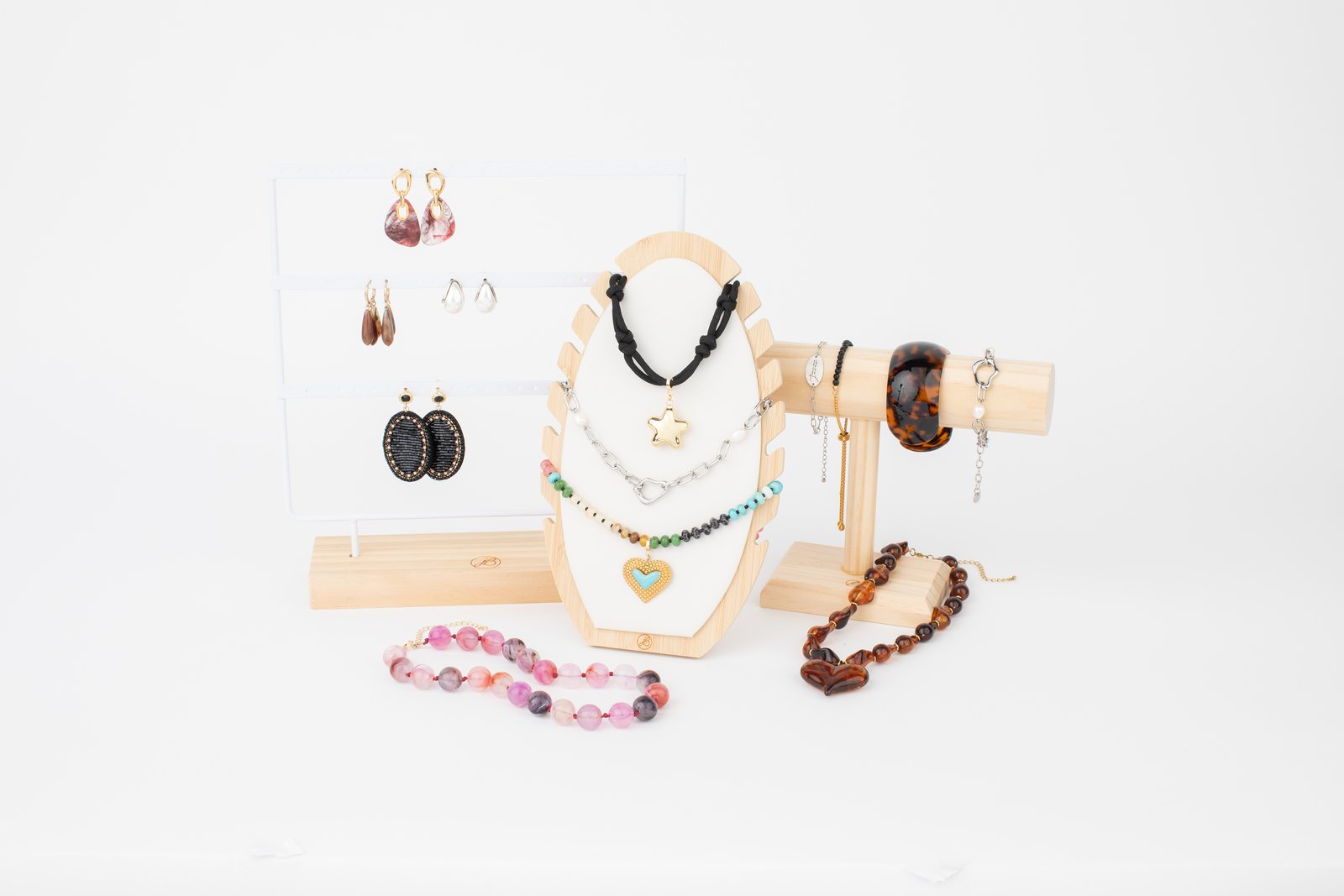Gold chains and bangles arranged on a wooden display stand