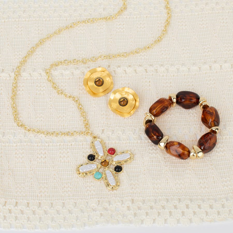 September Bloom Box contents: a gold and pearl pendant necklace, gold flower earrings and a tortoise bead bracelet